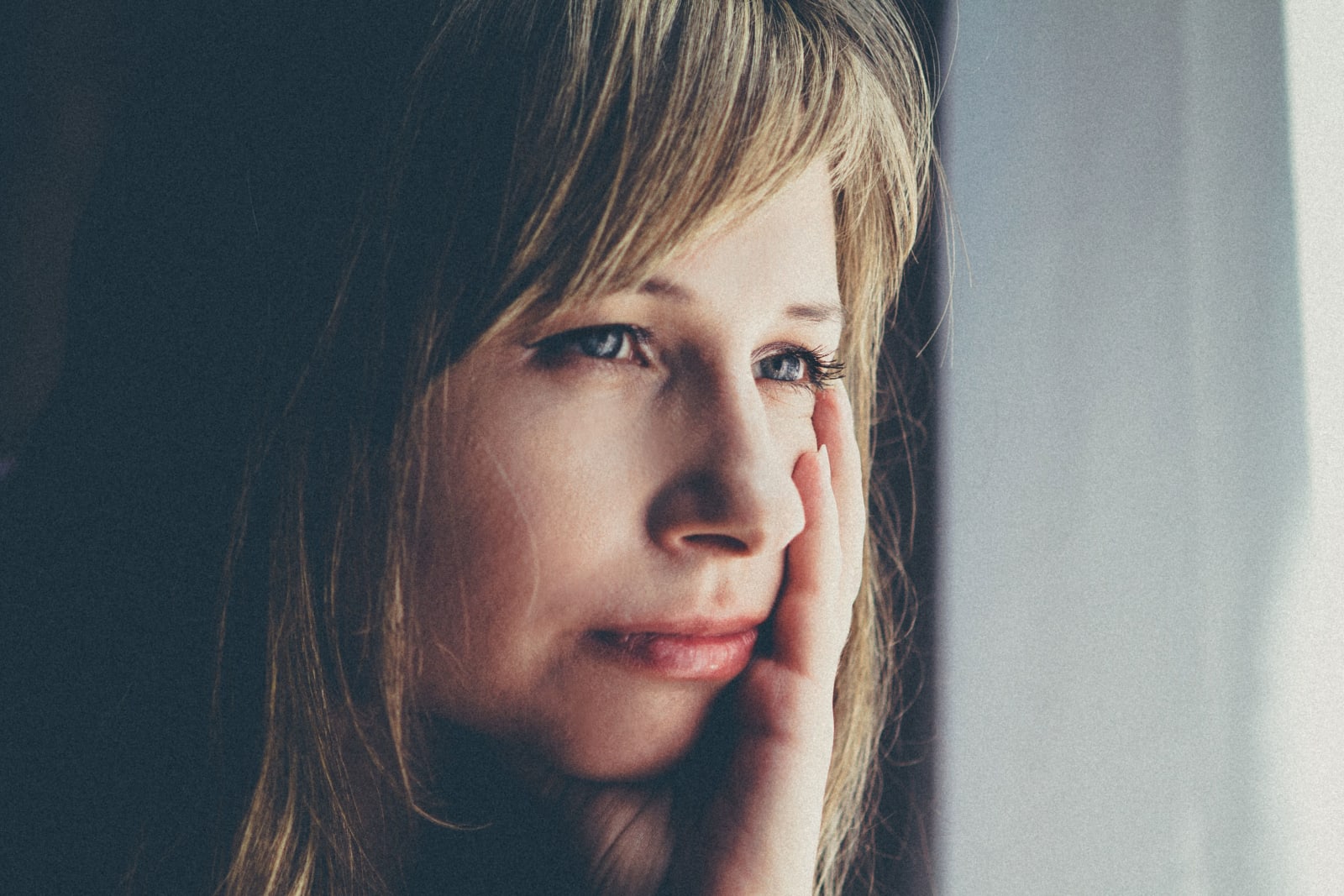 A woman looks shocked and is in deep thought.