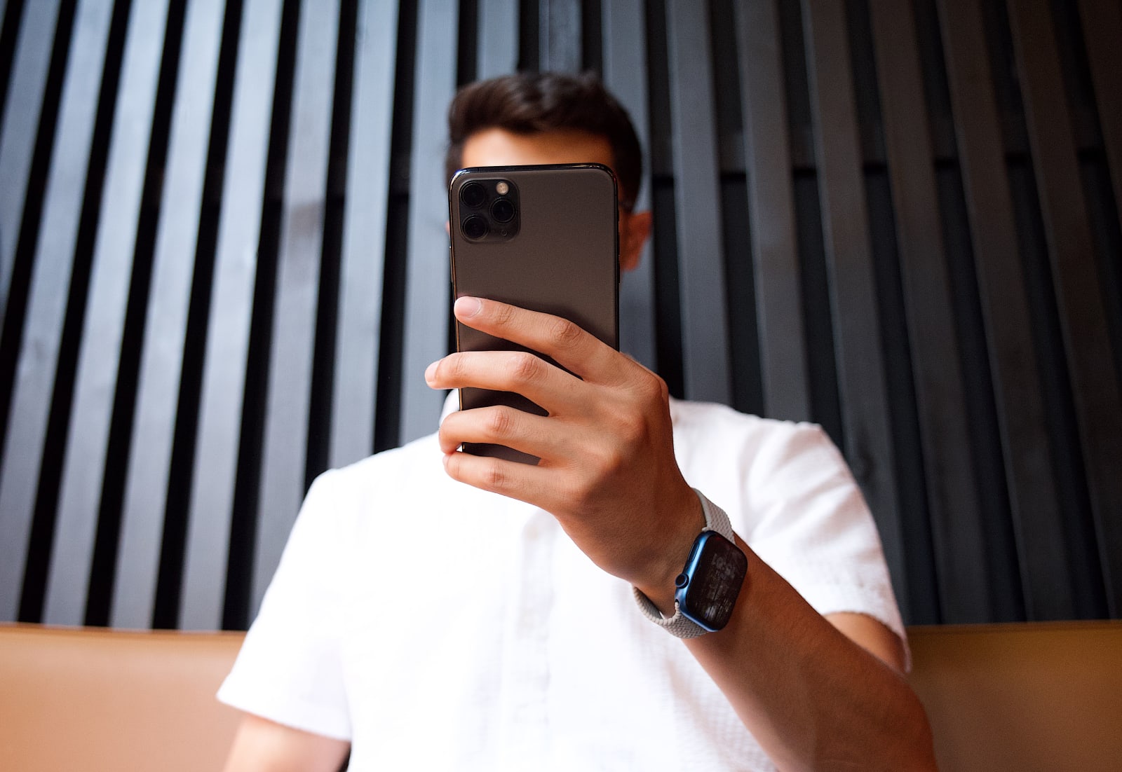 A person is recording someone using his phone.