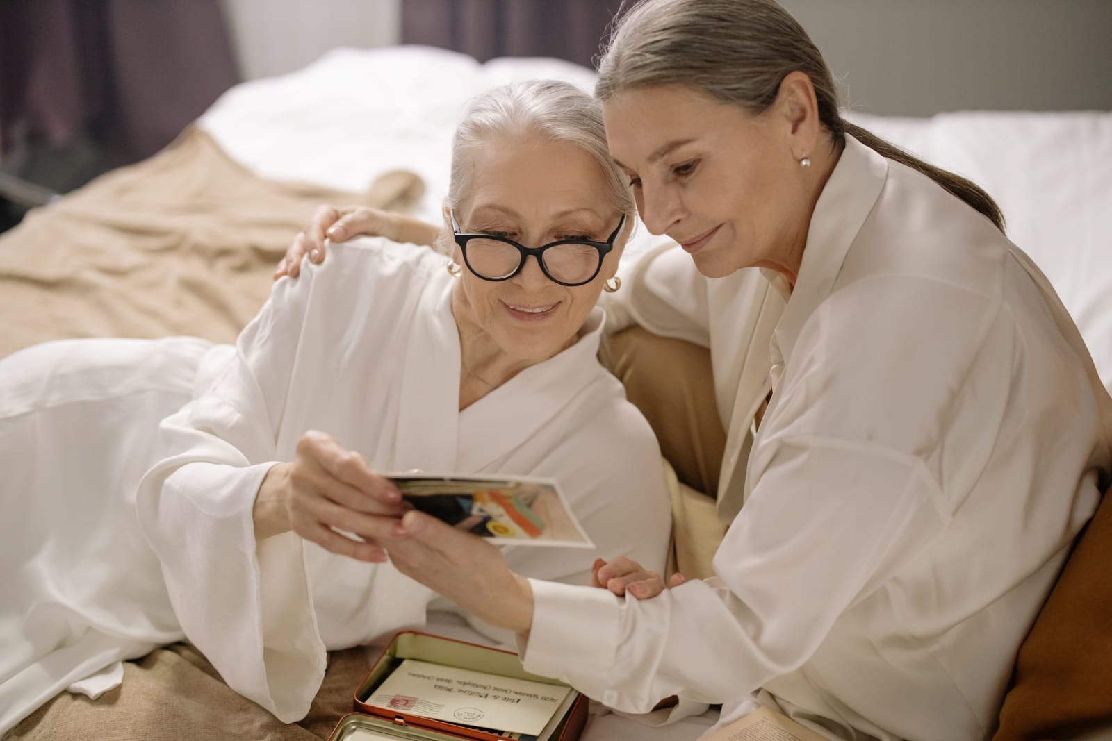 Two elderly woman reminiscing.
