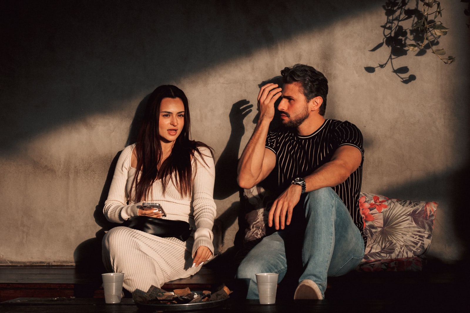 A woman is talking to a man at an outdoor event.