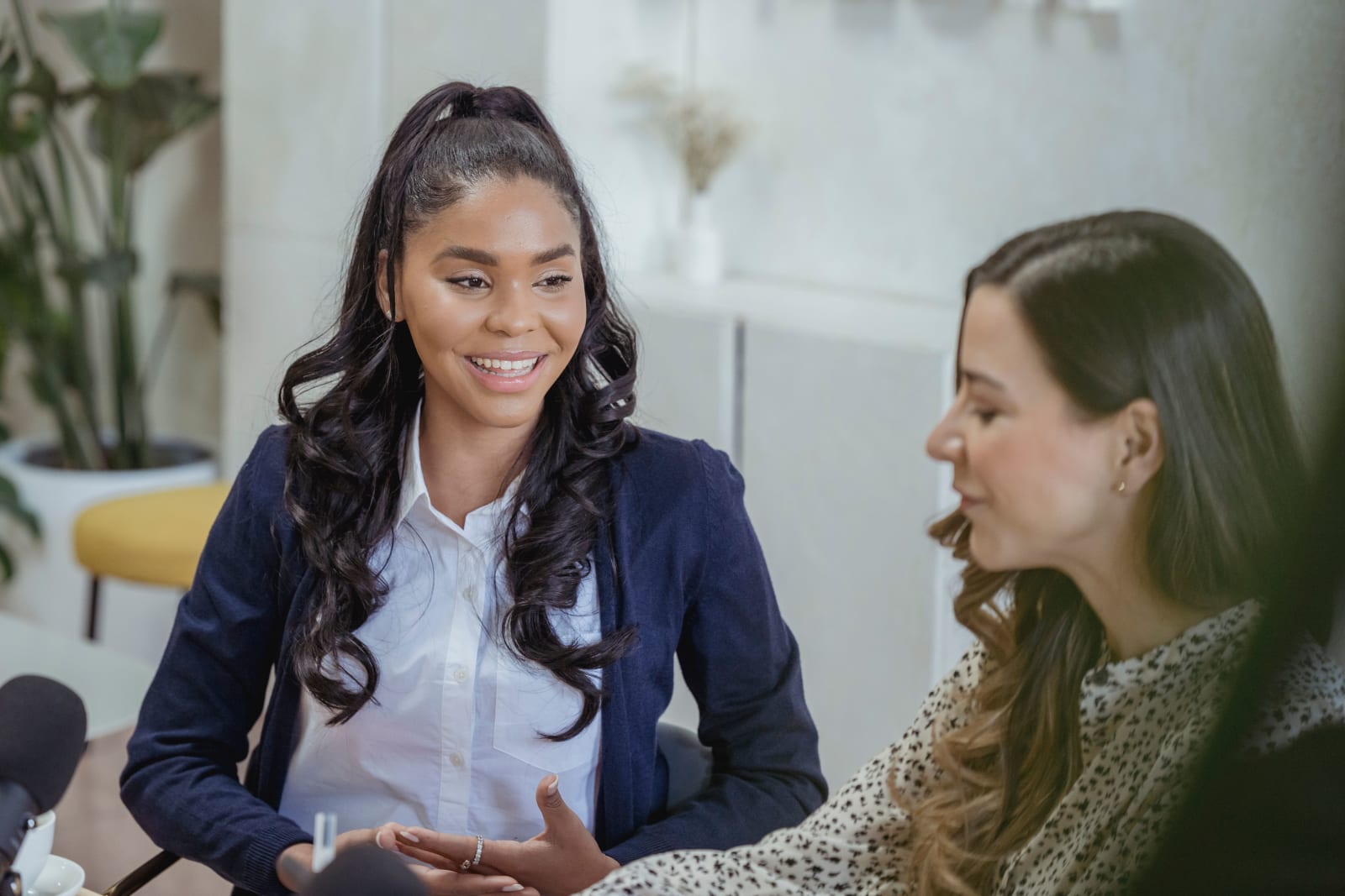 A woman is speaking to her manager at work.