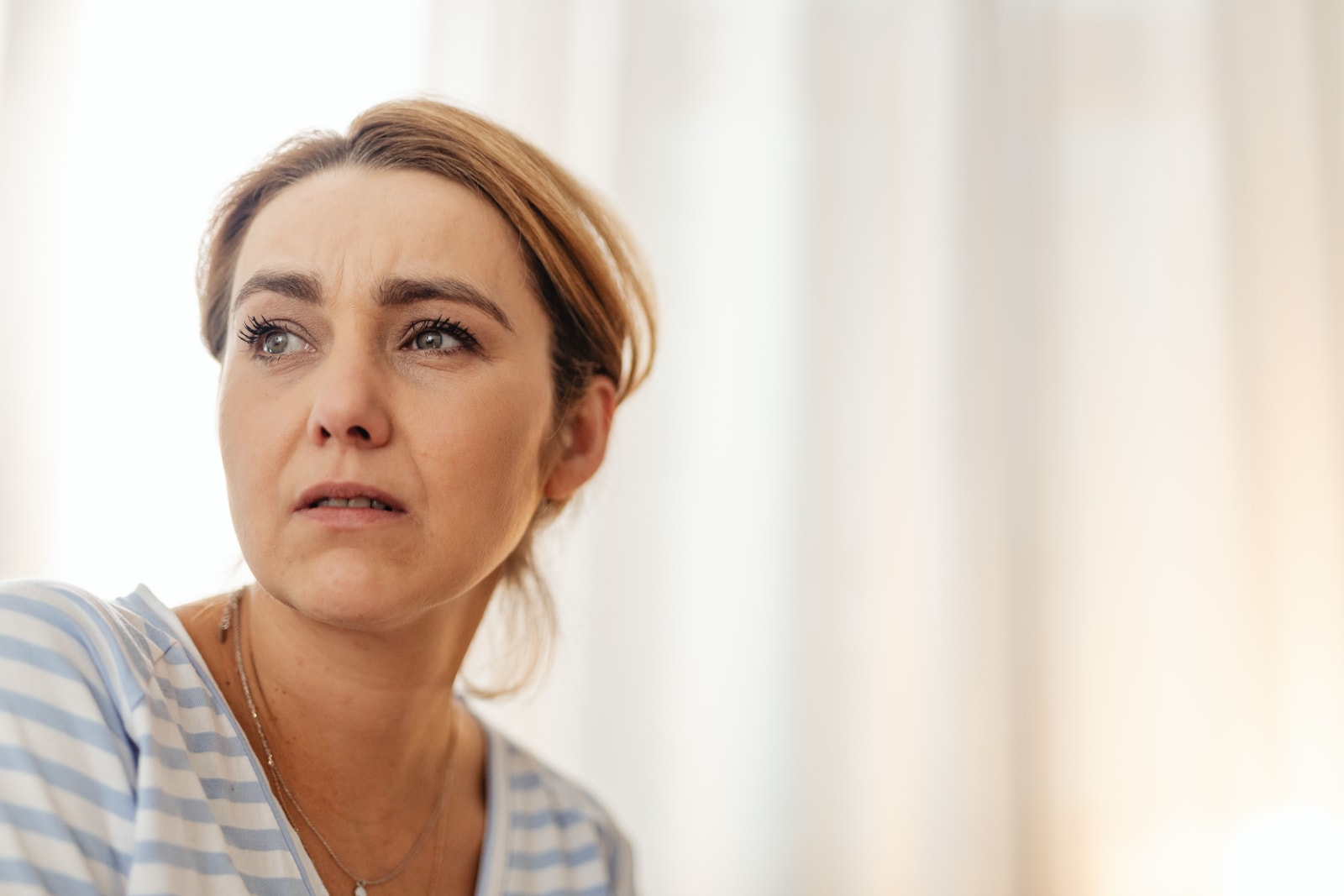A woman looks confused and annoyed.