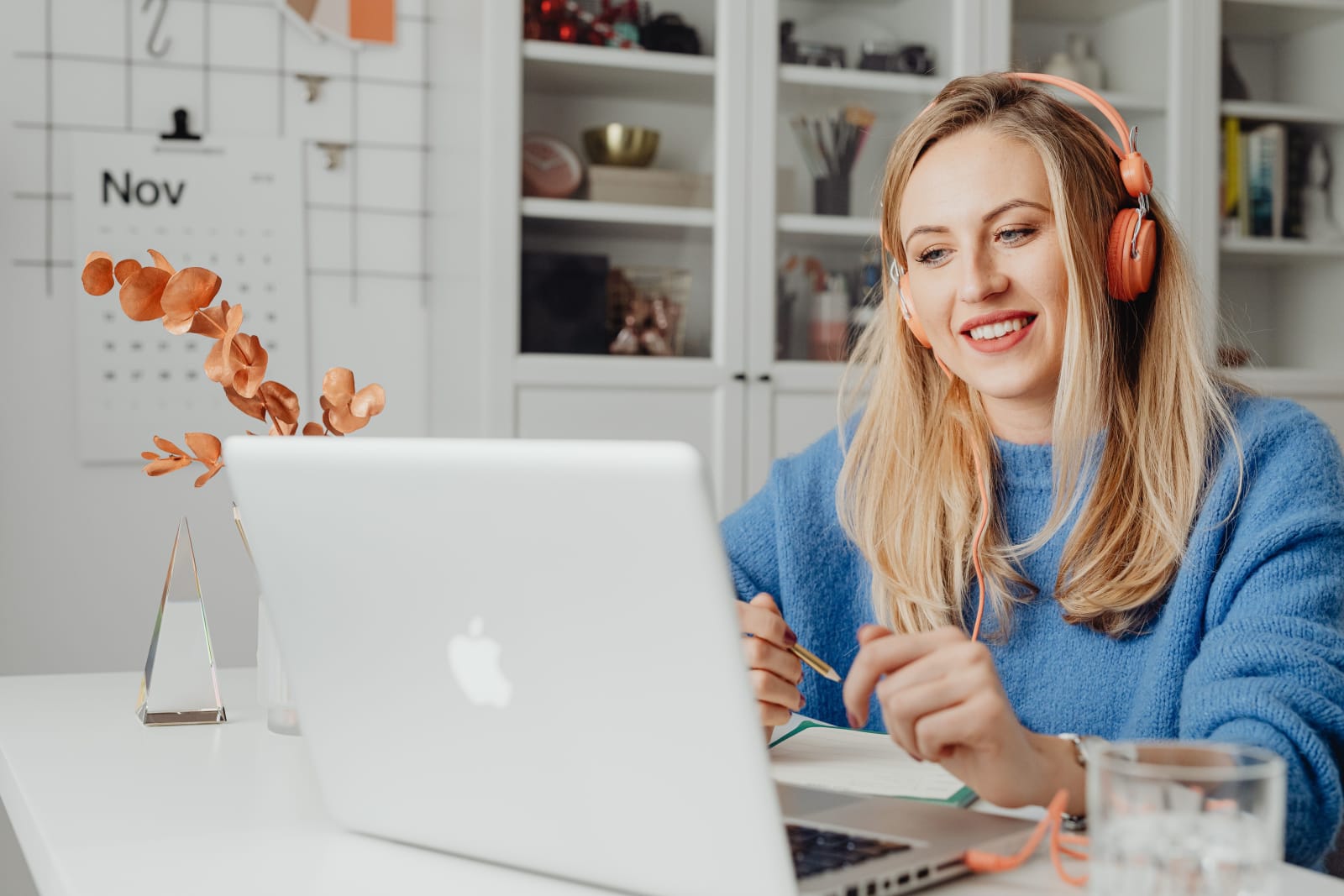 A woman is speaking to a client on video call.