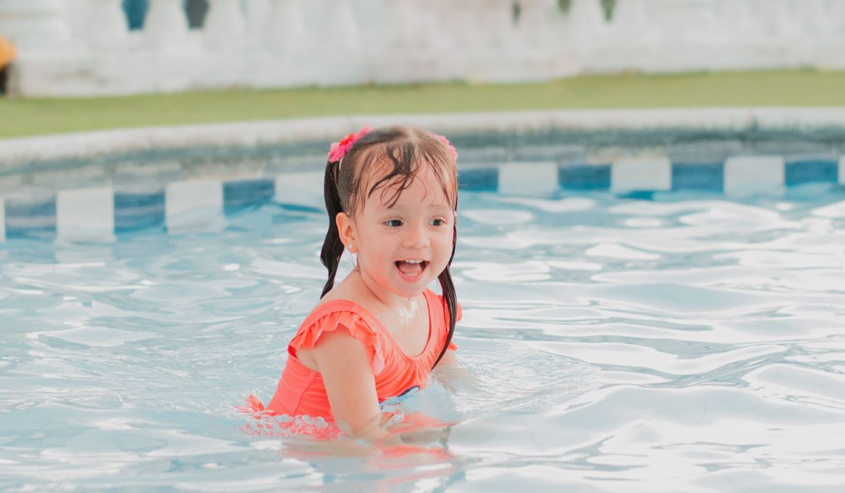 A cheerful girl enjoying water play. (Representative Image Source: Pexels | Esteban Garcia)