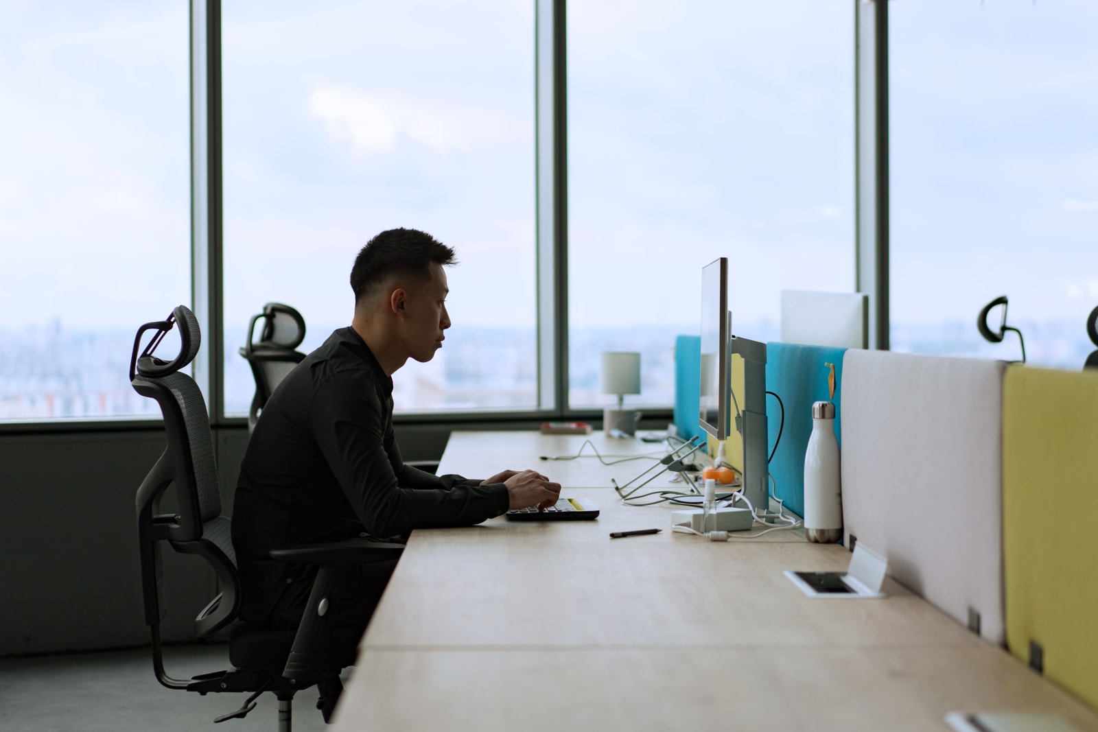 A man sitting and working alone in the office.