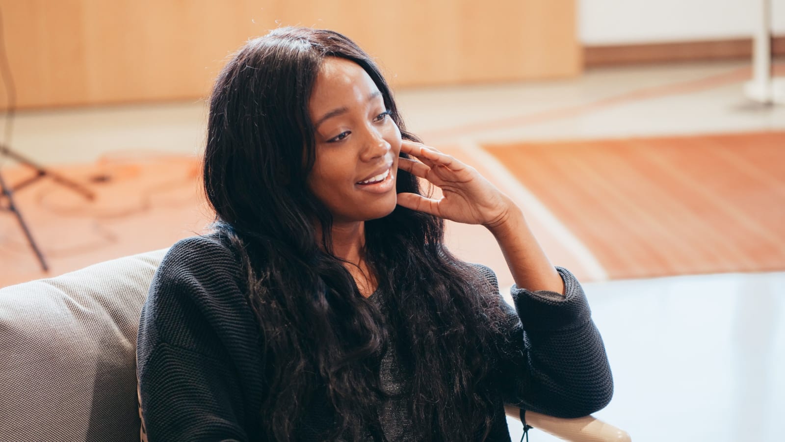 A woman smirks while speaking.