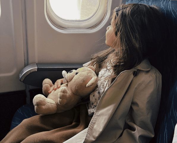 A little girl sitting in a plane.