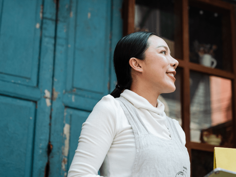A waitress smiling at someone.