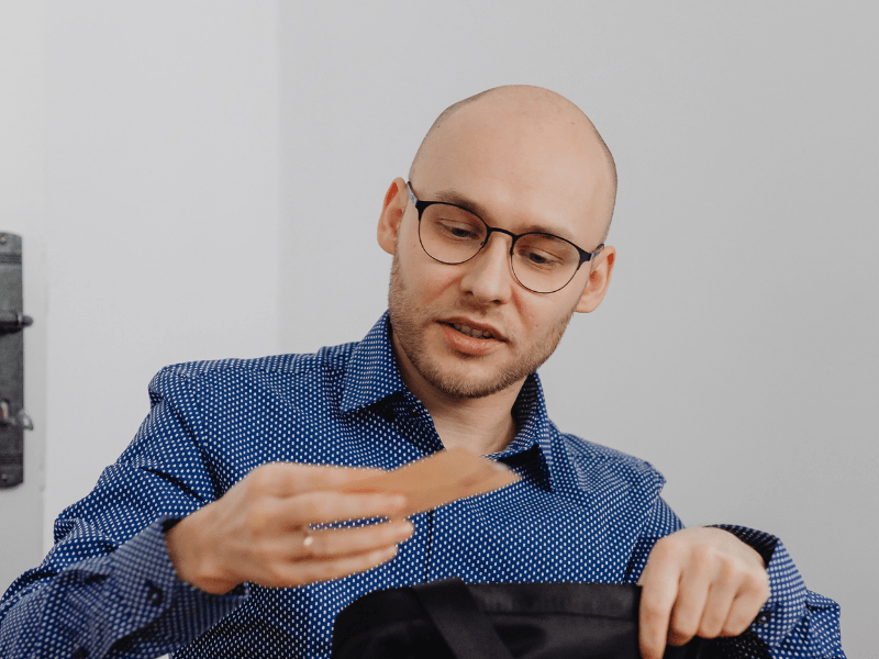 A man reading a note out from his bag.