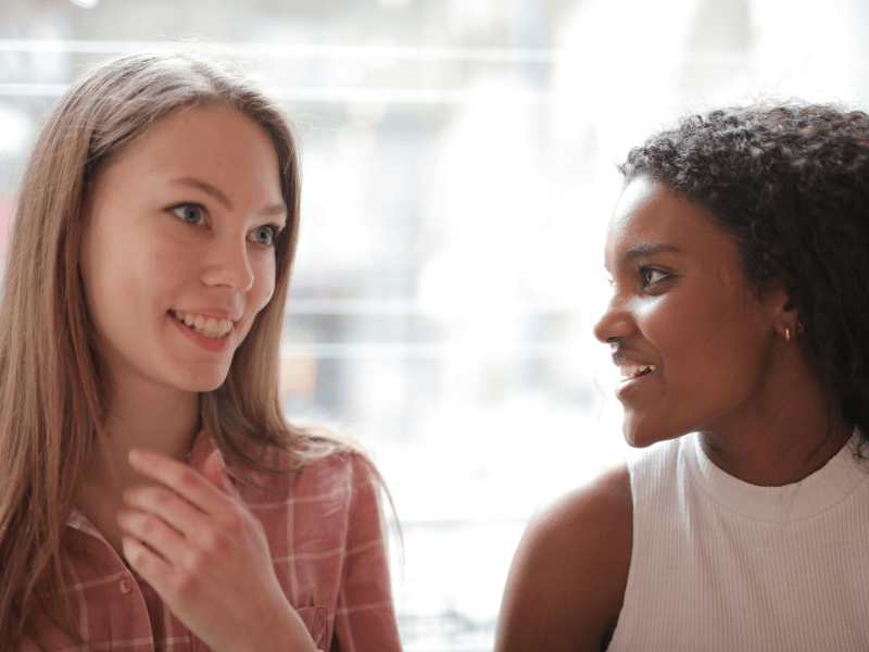 Two women talking to each other.