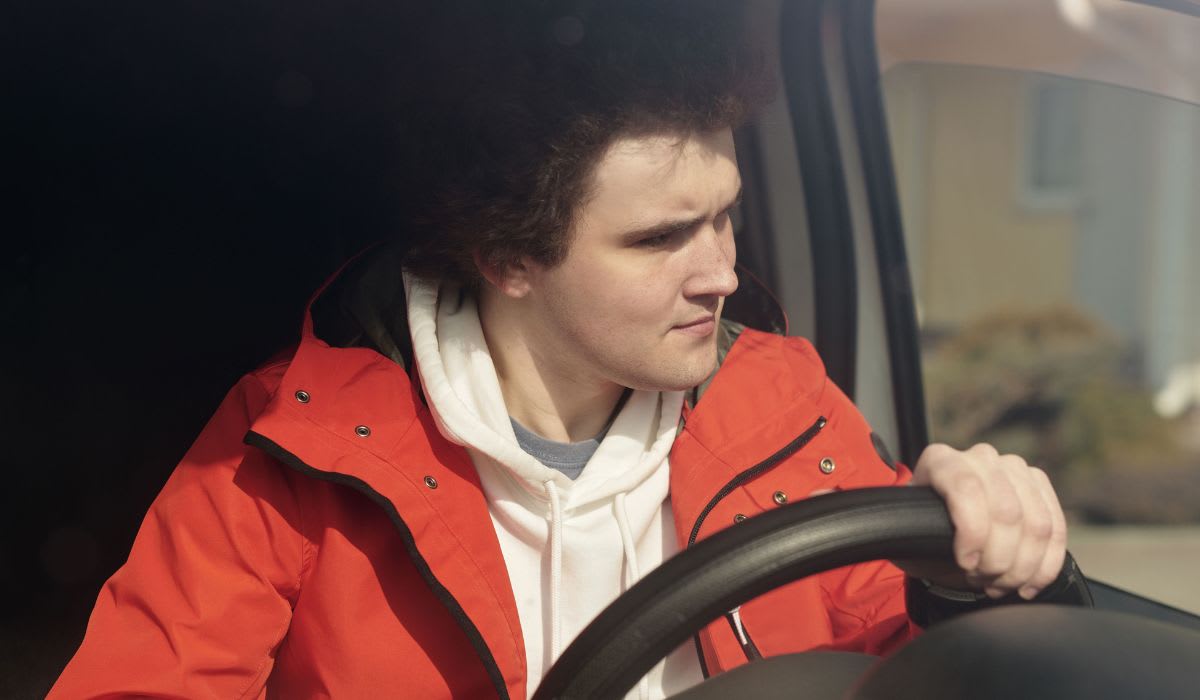 Boy in a red jacket steering a car. (Representative Image Source: Pexels | Norma Mortenson)
