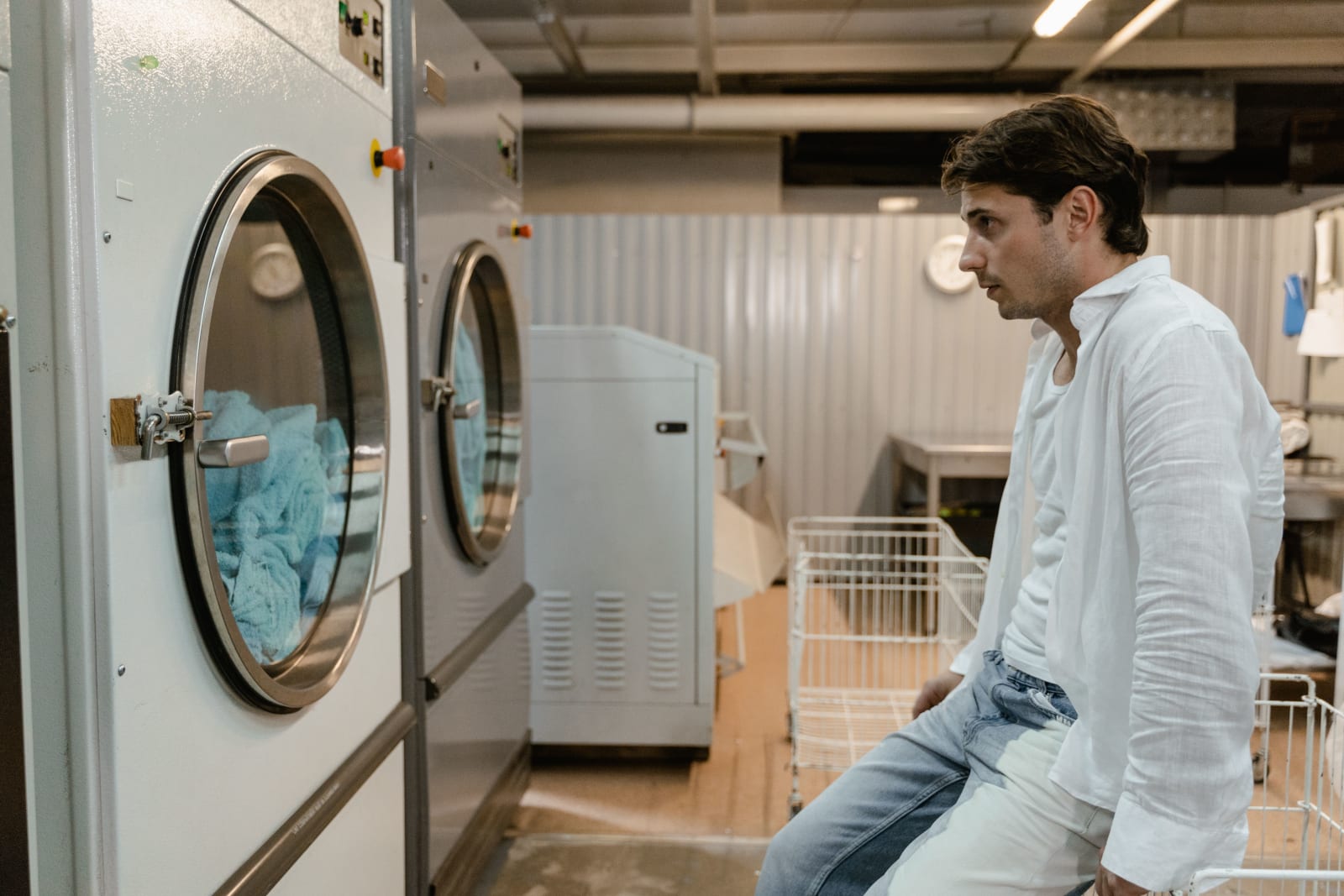 A man is doing laundry.