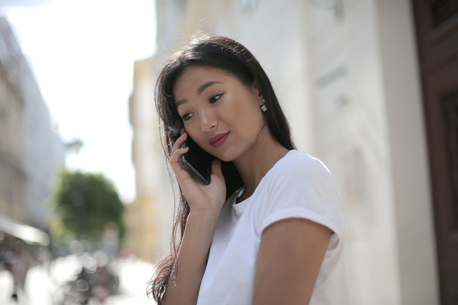 A worried woman is speaking on a call.