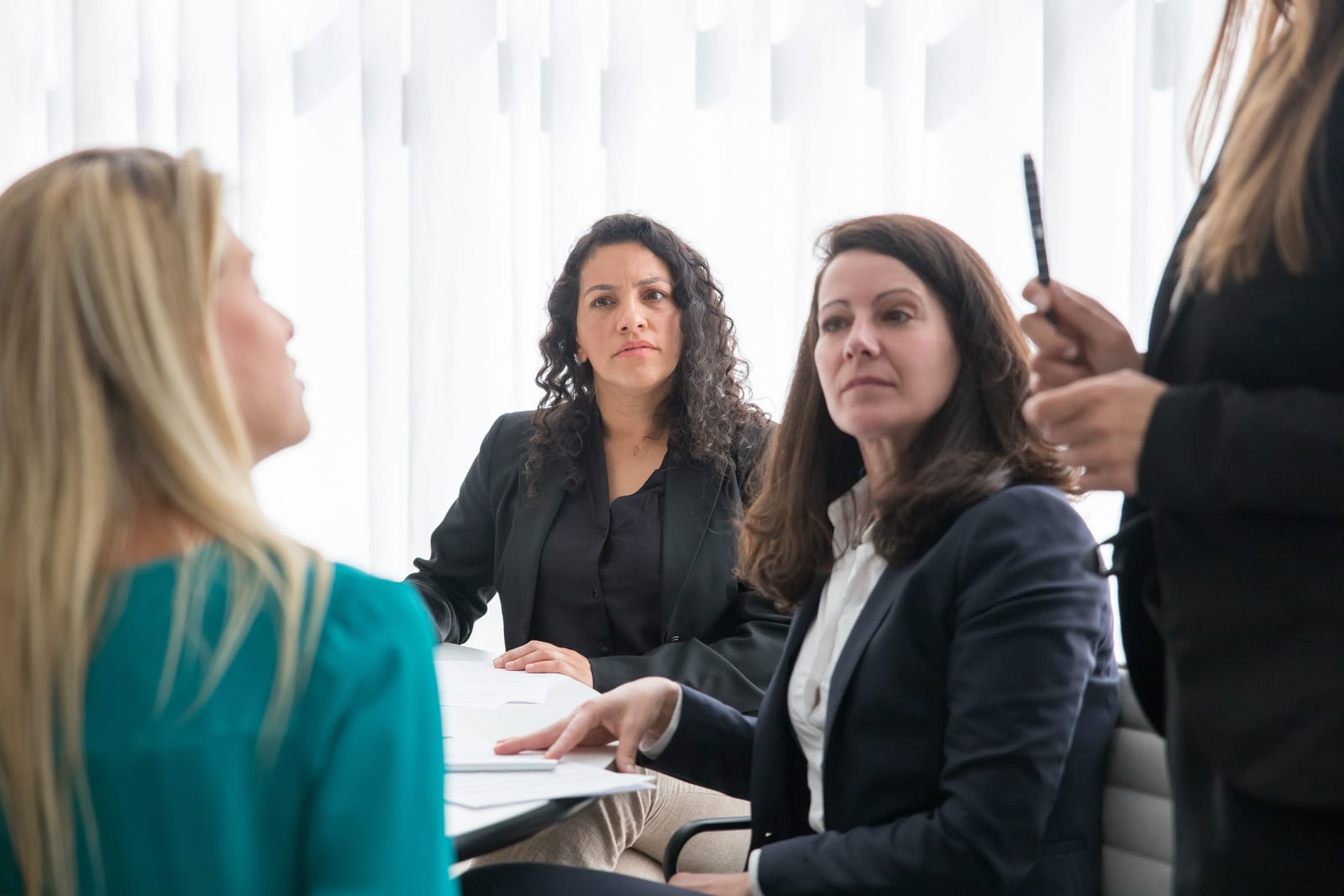 Female colleagues are speaking each other.