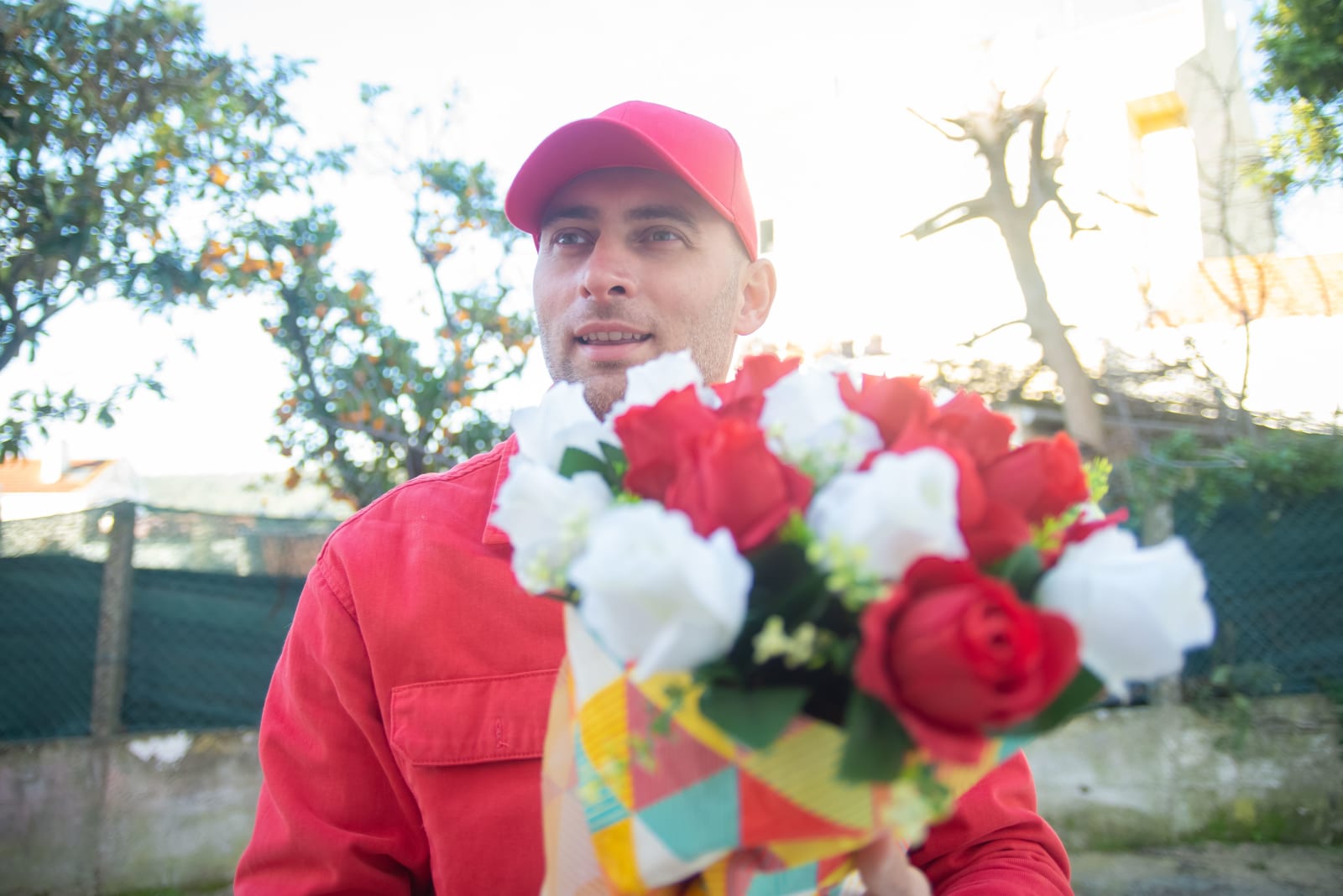 A man waiting with flowers for somene