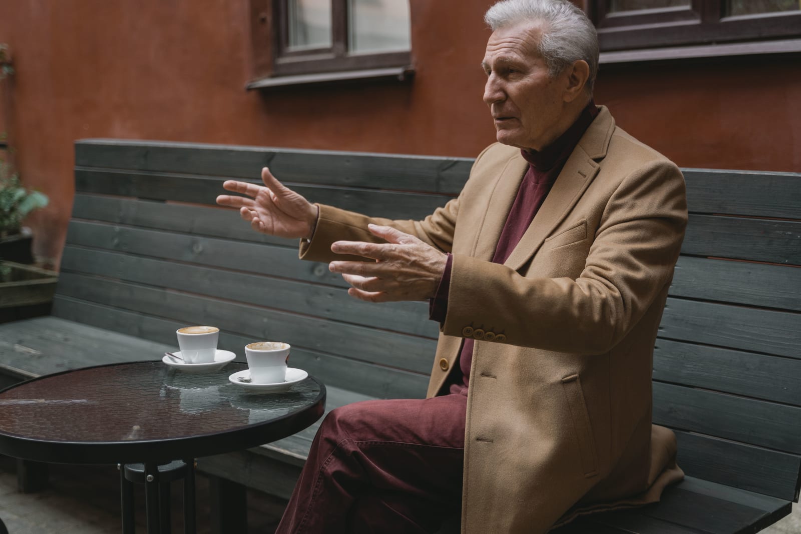 An elderly man speaking.