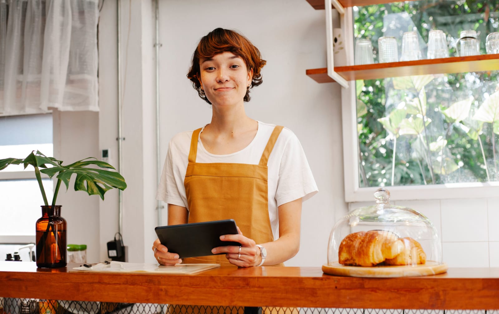 A barista smiles at a customer.