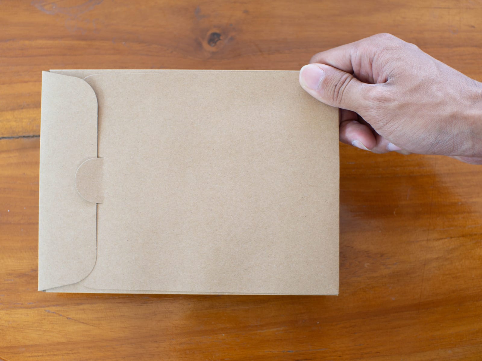 A person holding paper bag.