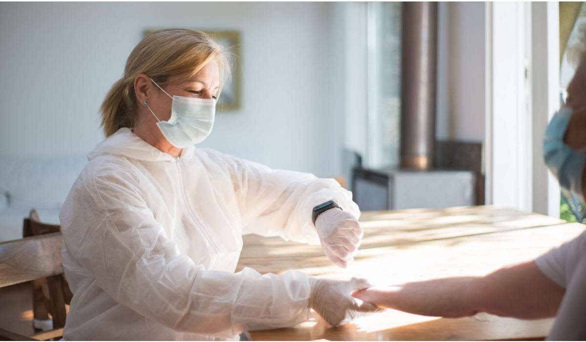 Healthcare professional in protective gear attending to a patient. (Representative Image Source: Pexels | Kampus Production)