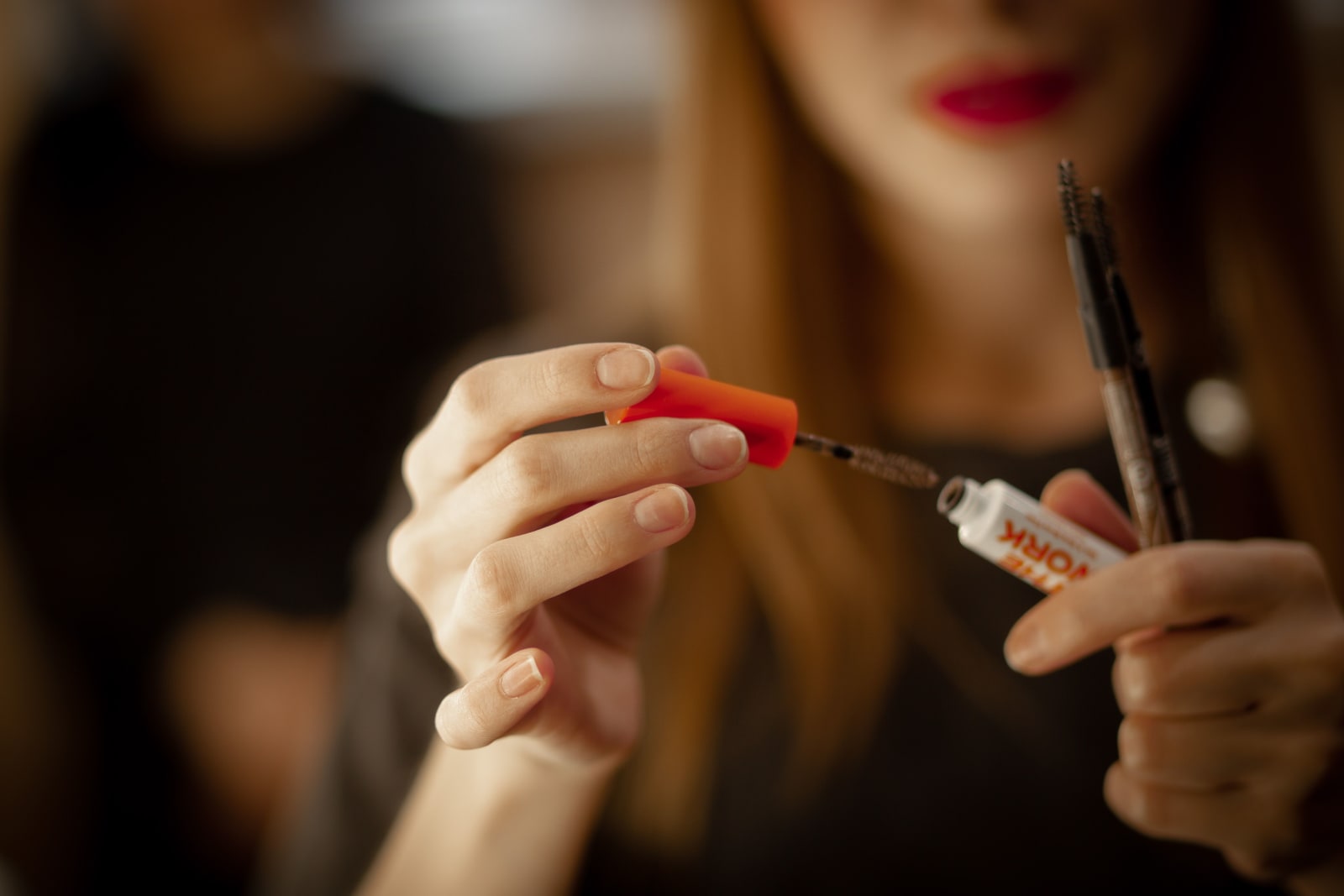 A woman is trying makeup products.