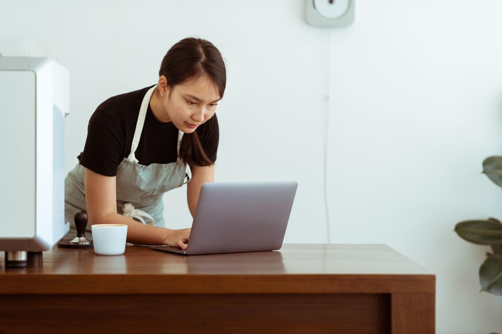 An employee looking intently at footage on a laptop. (Representative Image Source: Pexels| Amina Filkins)