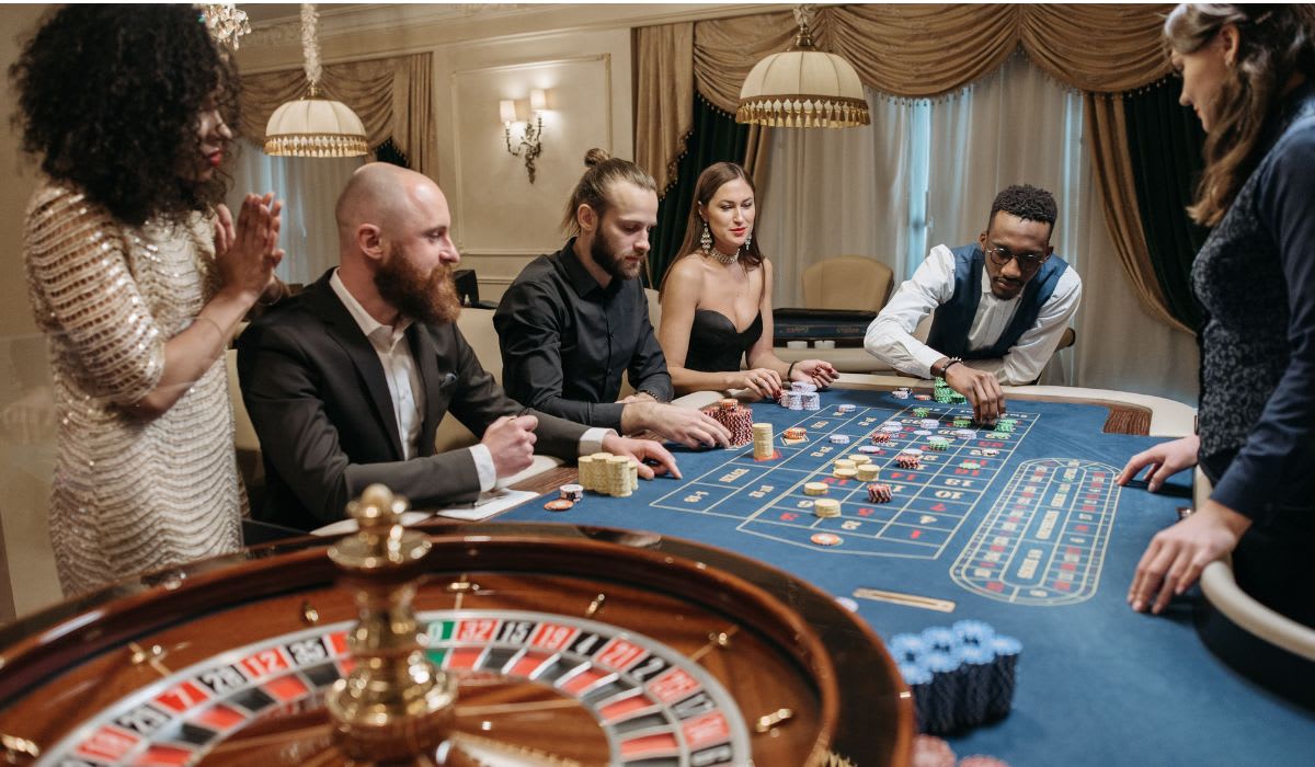 A group of people engaged in a casino game around a roulette table. (Representative Image Source: Pexels | Pavel Danilyuk)