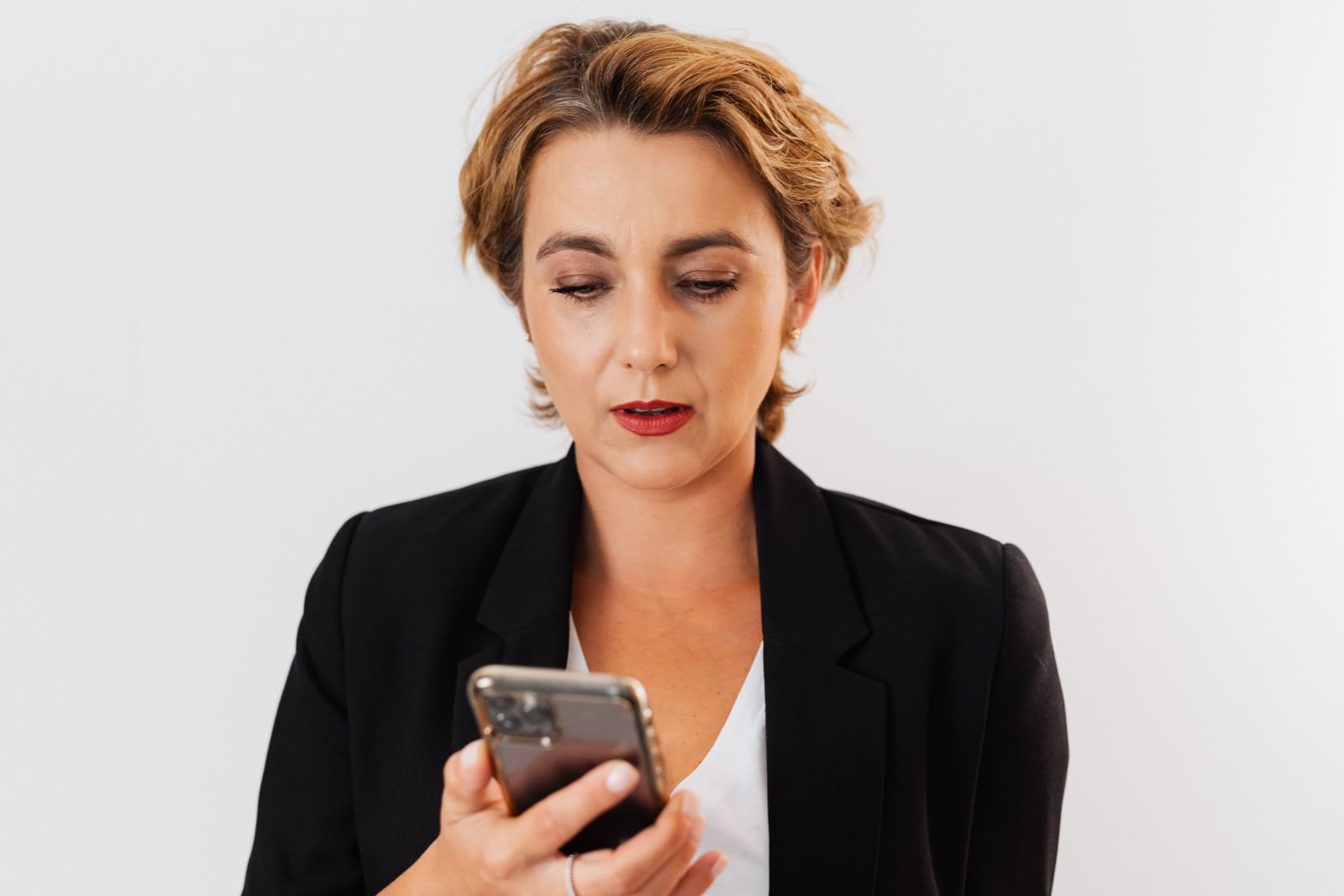 A woman looks at her phone disappointedly. (Representative Image Source: Pexels| Karola G)