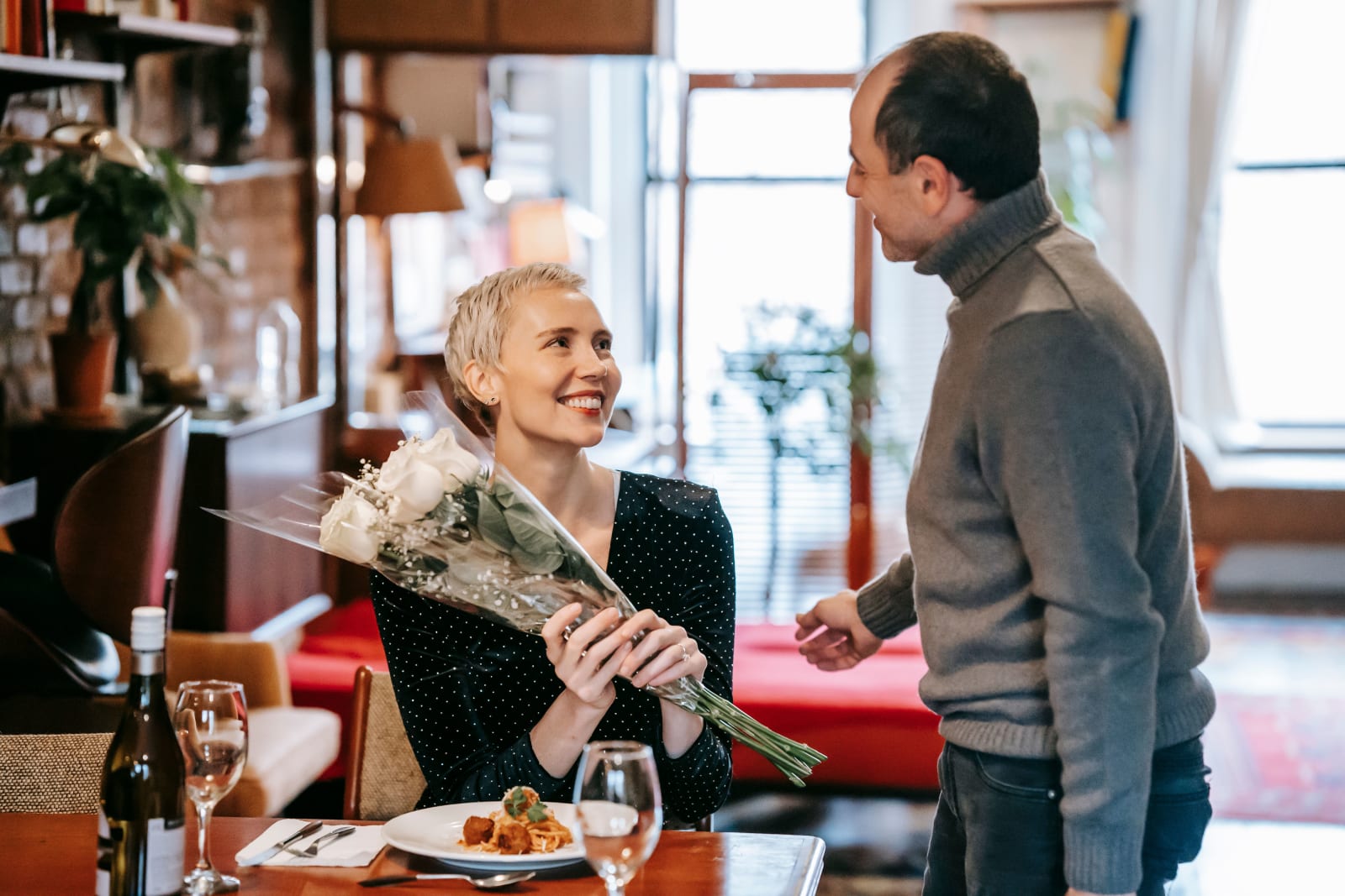A woman receiving flowers on her date.