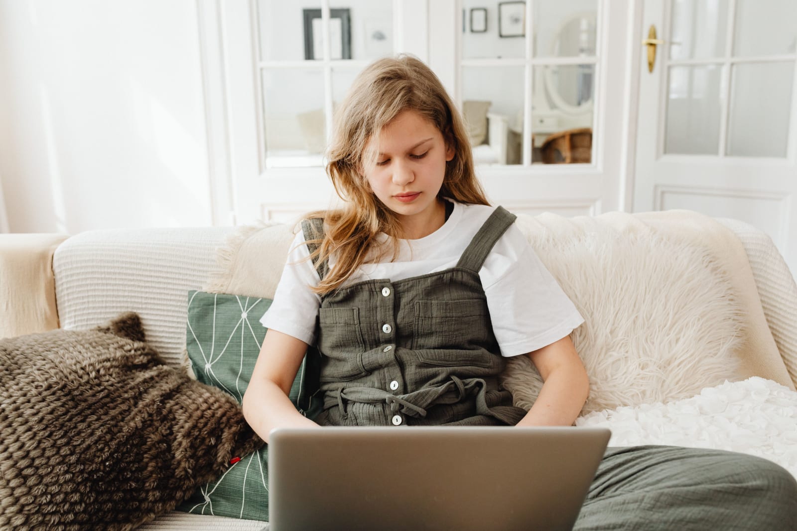 A teenage girl is using her laptop at home. (Representative Image Source: Pexels| Karola G)|
