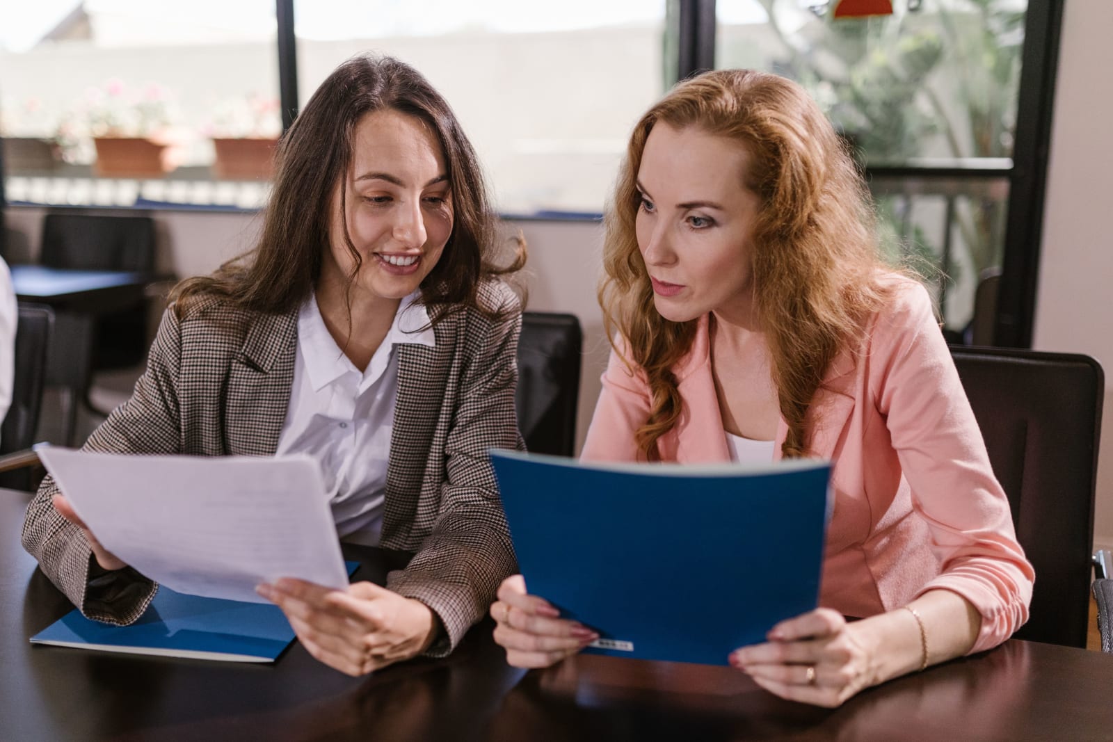 A woman talking to a client in an office. (Representative Image Source: Pexels| RDNE Stock Project)