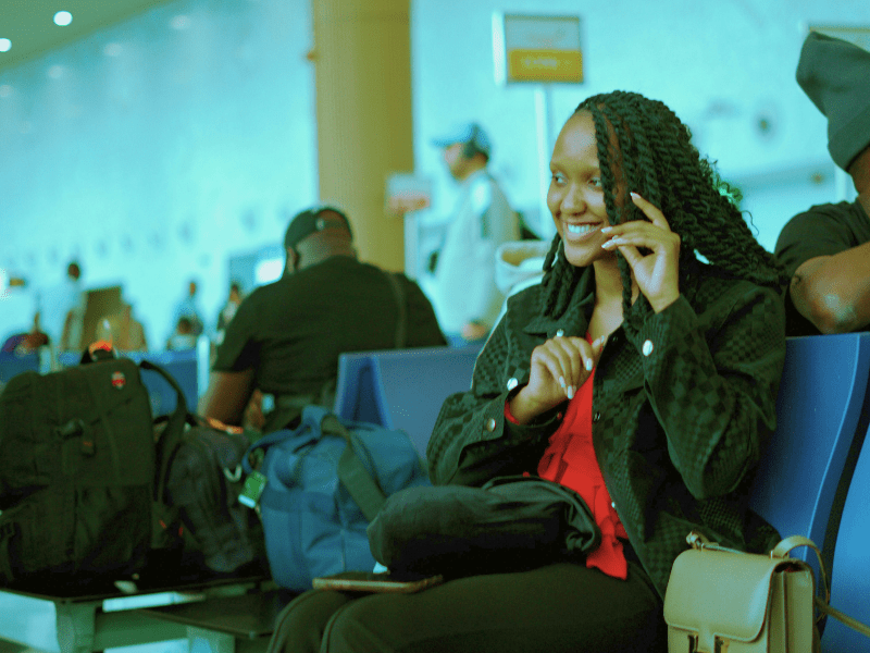 A woman waiting at the boarding gate waiting lounge.