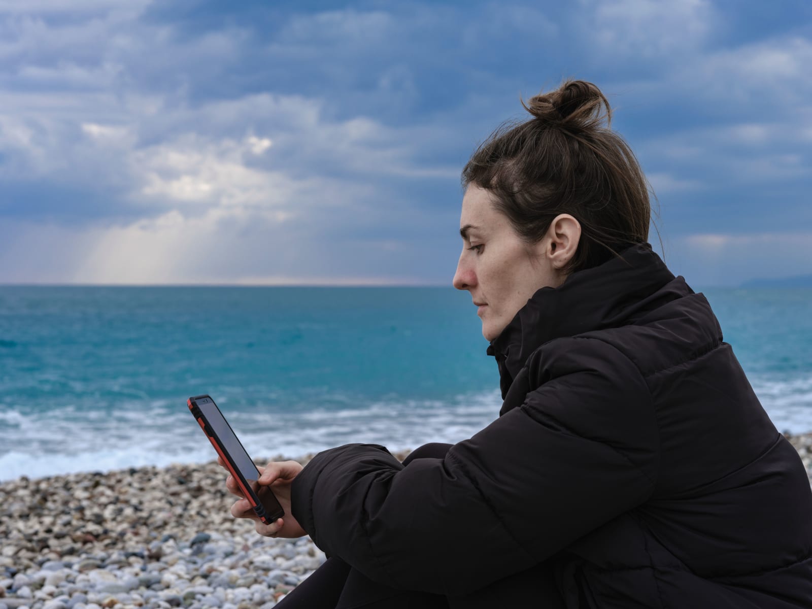A woman looks at her phone emotionally. (Representative Image Source: Pexels| Enging Akyurt)
