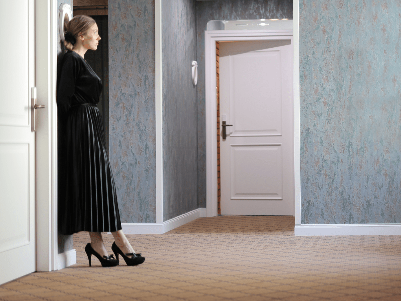A woman waiting outside in the hall.