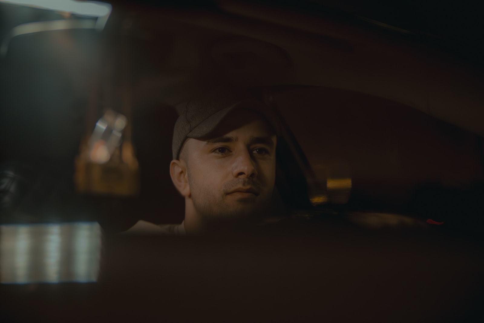 A man looks intently from his car. (