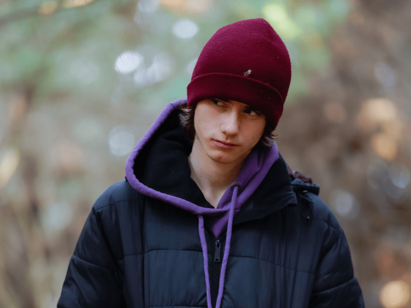 A teenager boy in the outdoors staring at someone with anger. — Image Source: Pexels| Mornie Jeremiah