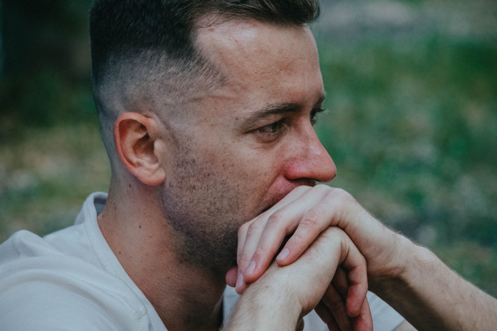 A young man looks emotional while observing someone. (Representative Image Source: Pexels| T. Zhuravel)