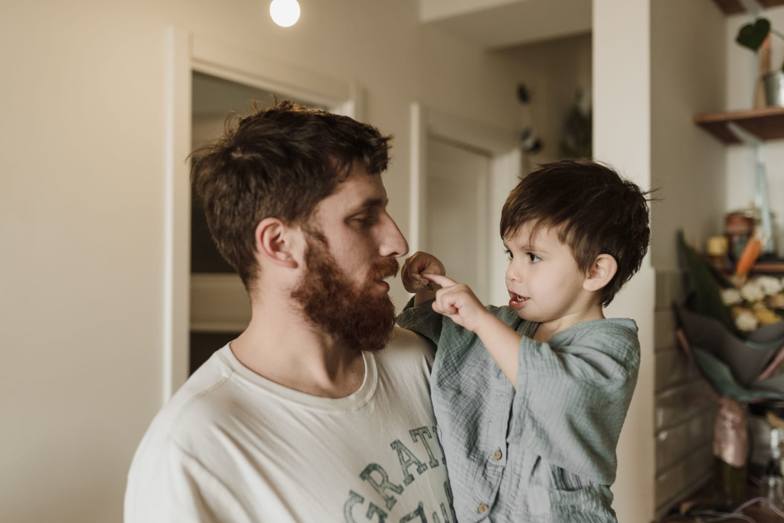 A father and his young son share a playful moment at home. (Representative Image Source: Pexels | Arina Krasnikova)