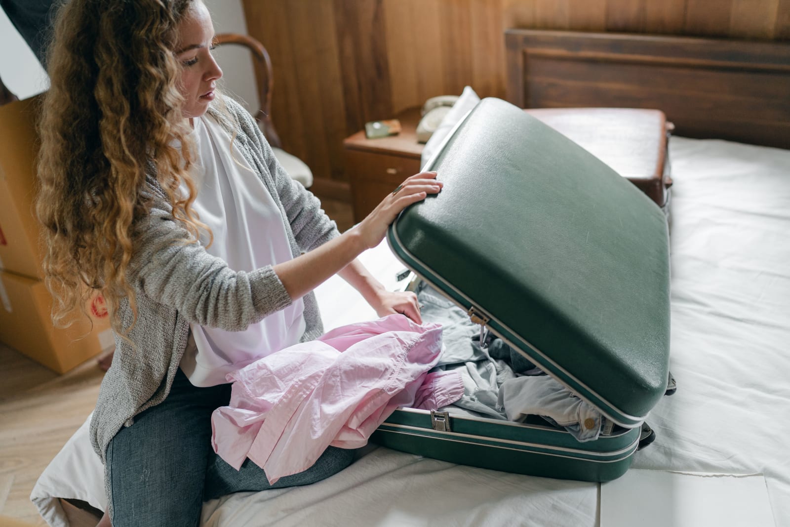 A woman is unpacking her luggage. (Representative Image Source: Pexels| Ketut Subiyanto)