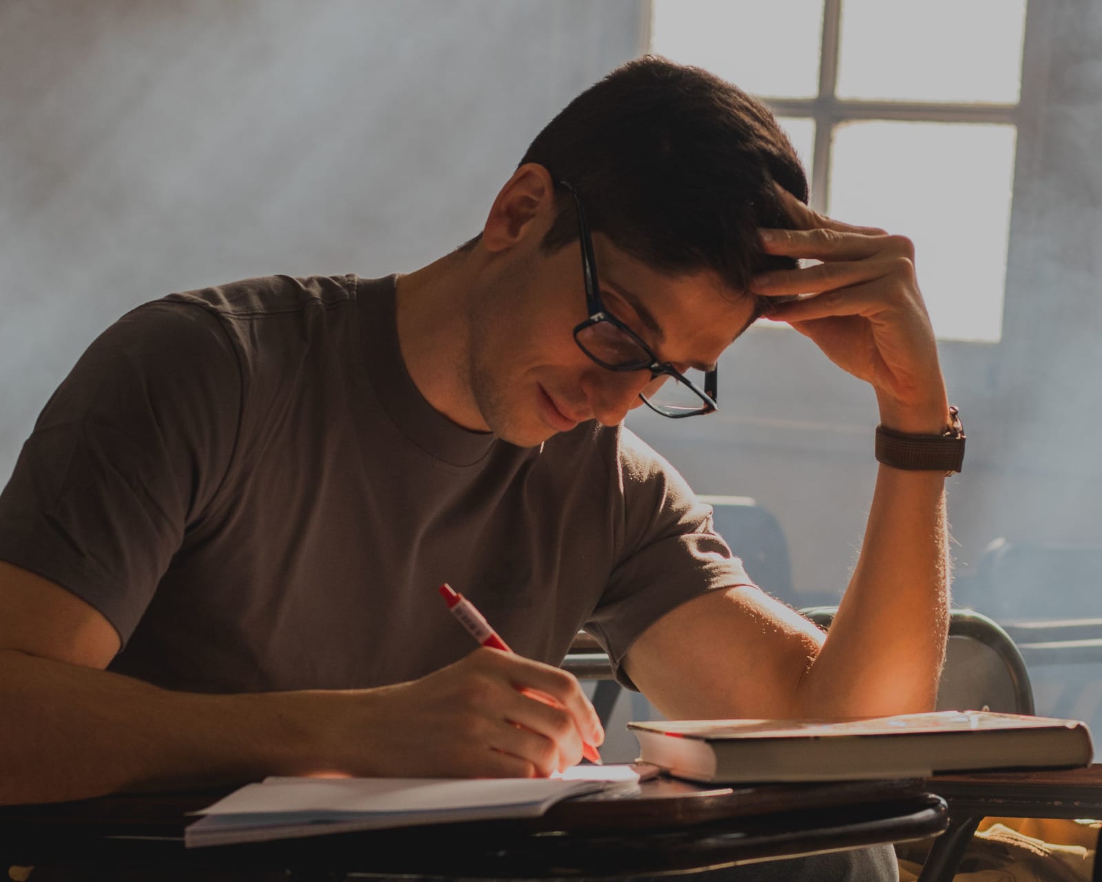 A young man with glasses intensely focused (Representative Image Source: Pexels | Franco Solis)