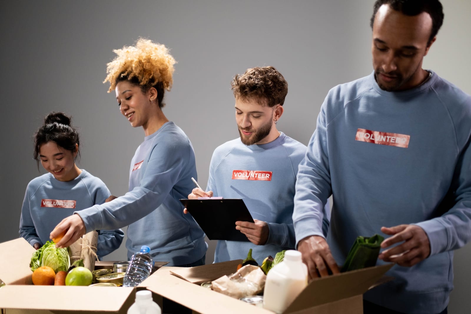Four volunteers pack food donations (Representative Image Source: Pexels | cottonbro studio)