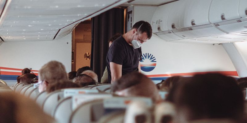 Passenger looking for his seat on an airplane (Representative Image Source: Pexels, Hasan Gulec)
