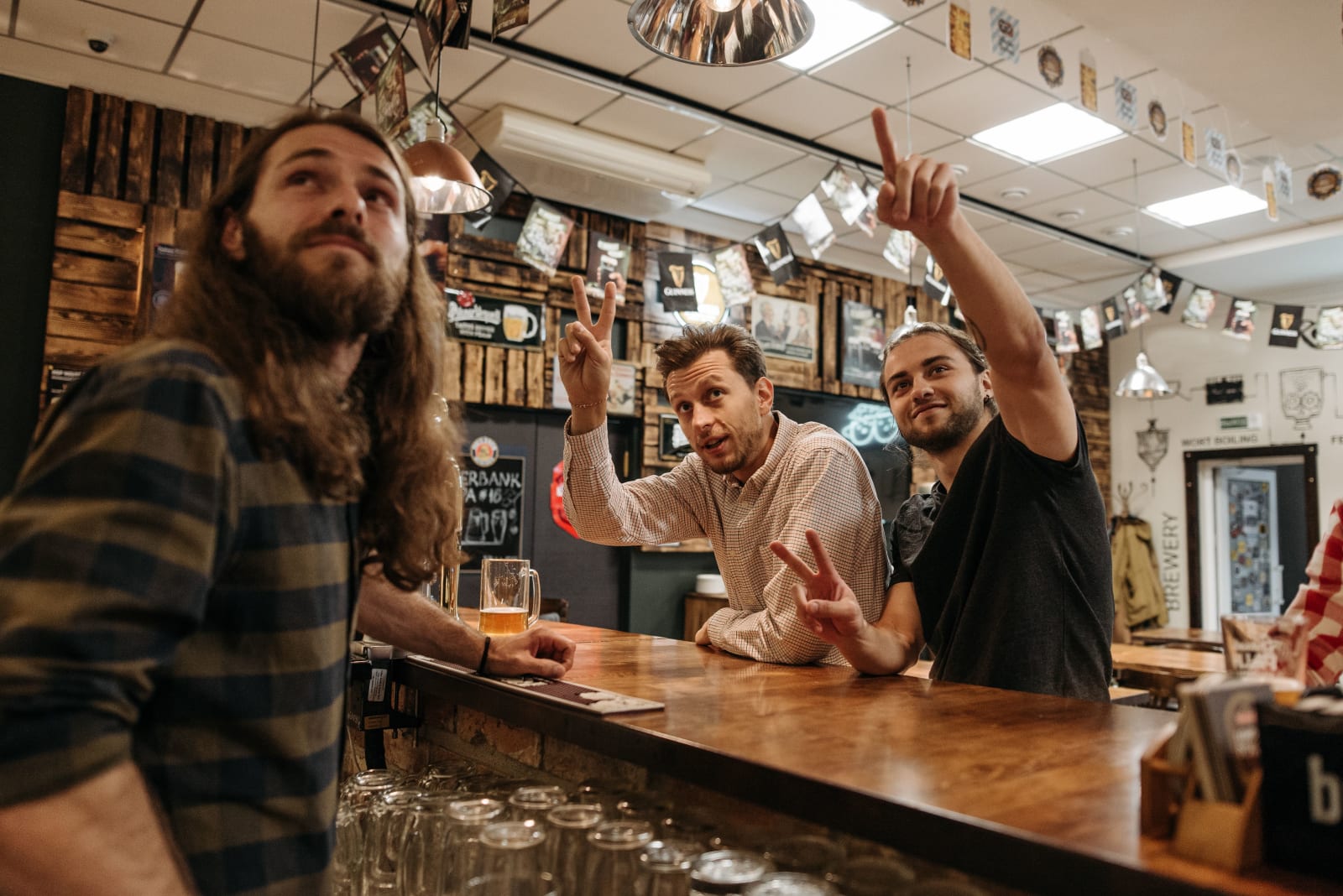 Men at a bar are enjoying a match on the TV. (Representative Image Source: Pexels| Pavel Danilyuk)