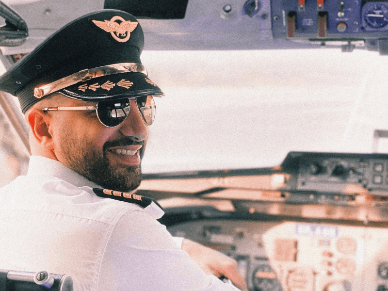A pilot smiling while on on-board.