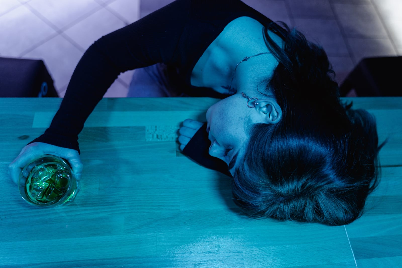A woman passed out at a bar. (Representative Image Source: Pexels| Mart Production)