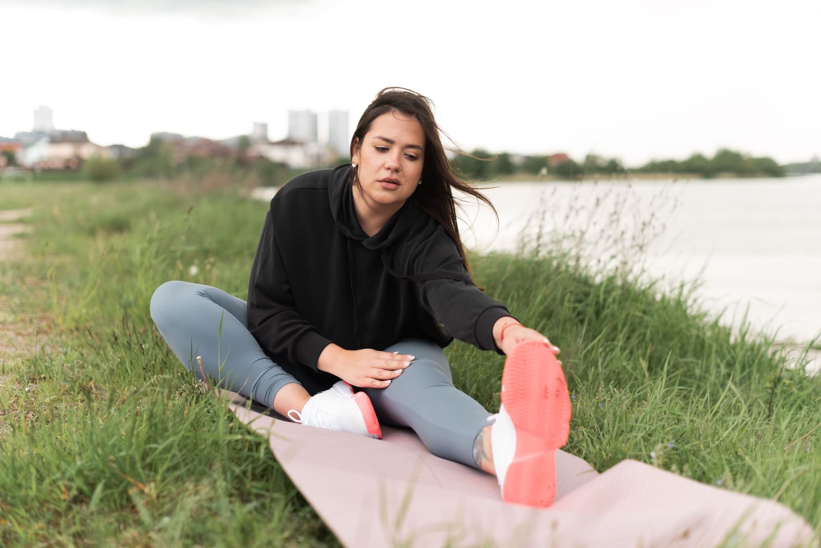 Woman checking her toe in pain while doing yoga. (Representative Image Source: Pexels| Mikhail Nilov)